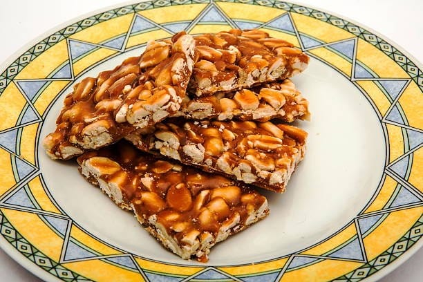 Groundnut Patti Laddu - A fusion of roasted groundnuts, besan, ghee, sugar, and cardamom