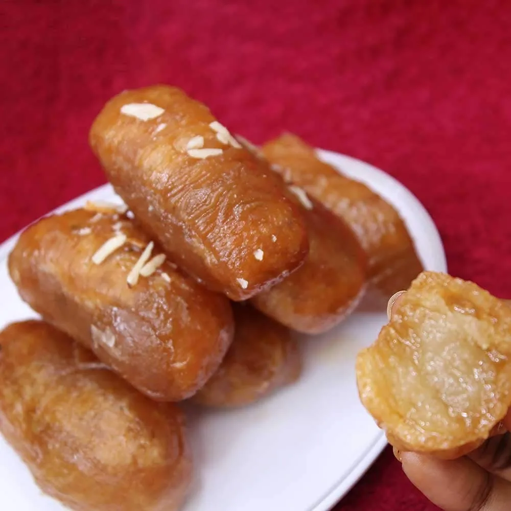 Kakinada Kaja - Crispy, syrup-soaked dessert made with flour, sugar, and cardamom, a traditional Indian sweet from Andhra Pradesh.