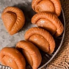 Kovapuri (Gujia) - Crispy, deep-fried pastry filled with rich Kova, sugar, and cardamom, a traditional Indian sweet for festive celebrations.